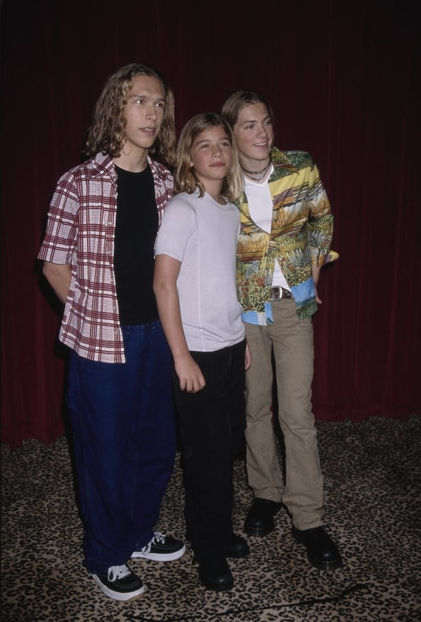 American pop rock band Hanson (L-R, singer and guitarist Isaac Hanson, drummer Zac Hanson, and singer and keyboard player Taylor Hanson) attend a press conference at Planet Hollywood in Beverly Hills, California, 10th July 1998. The press conference is to promote their forthcoming concert at the Hol