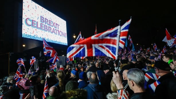 Revelers wave Union flags, also known as Union Jacks, during the Leave Means Leave celebration at Parliament Square in London, U.K