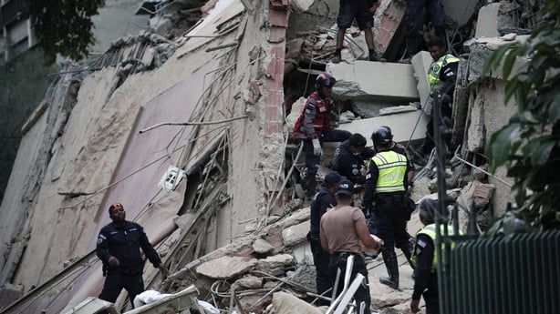 Rescuers search for victims in a collapsed building following an earthquake in Caracas on June 24, 2026. A magnitude 7.1 earthquake struck Venezuela on Wednesday, the United States Geological Survey (USGS) reported, triggering panic in Caracas, according to AFP journalists. The tremor, which was fol