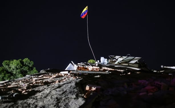 LA GUAIRA, VENEZUELA - JUNE 27: A Venezuelan flag raise amid debris of a demolished building after a magnitude 7.2 earthquake struck Venezuela and other regions in the Caribbean on June 27, 2026 in La Guaira, Venezuela. According to the U.S. Geological Survey (USGS), the main earthquake was followed