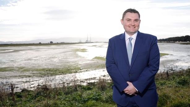 Daryl Barron standing in front of water