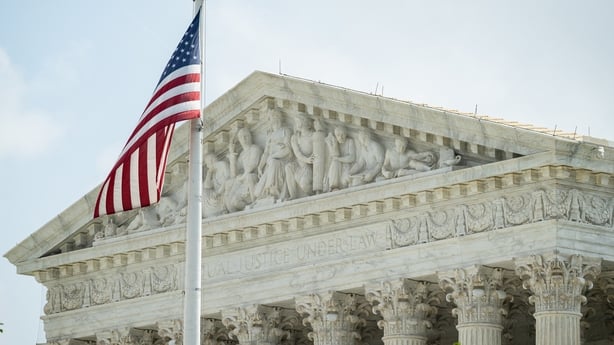 The US Supreme Court in Washington, DC along with flag