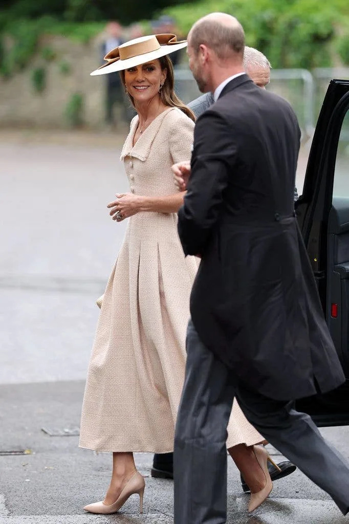 Catherine, Princess of Wales and Prince William, smiling and walking together