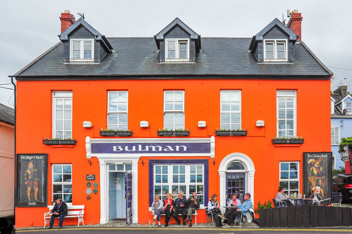 Kinsale, Ireland: May 25, 2015 - Patrons enjoy the afternoon at the famous Bulman Bar & Toddies in the coastal town of Kinsale, County Cork, Ireland