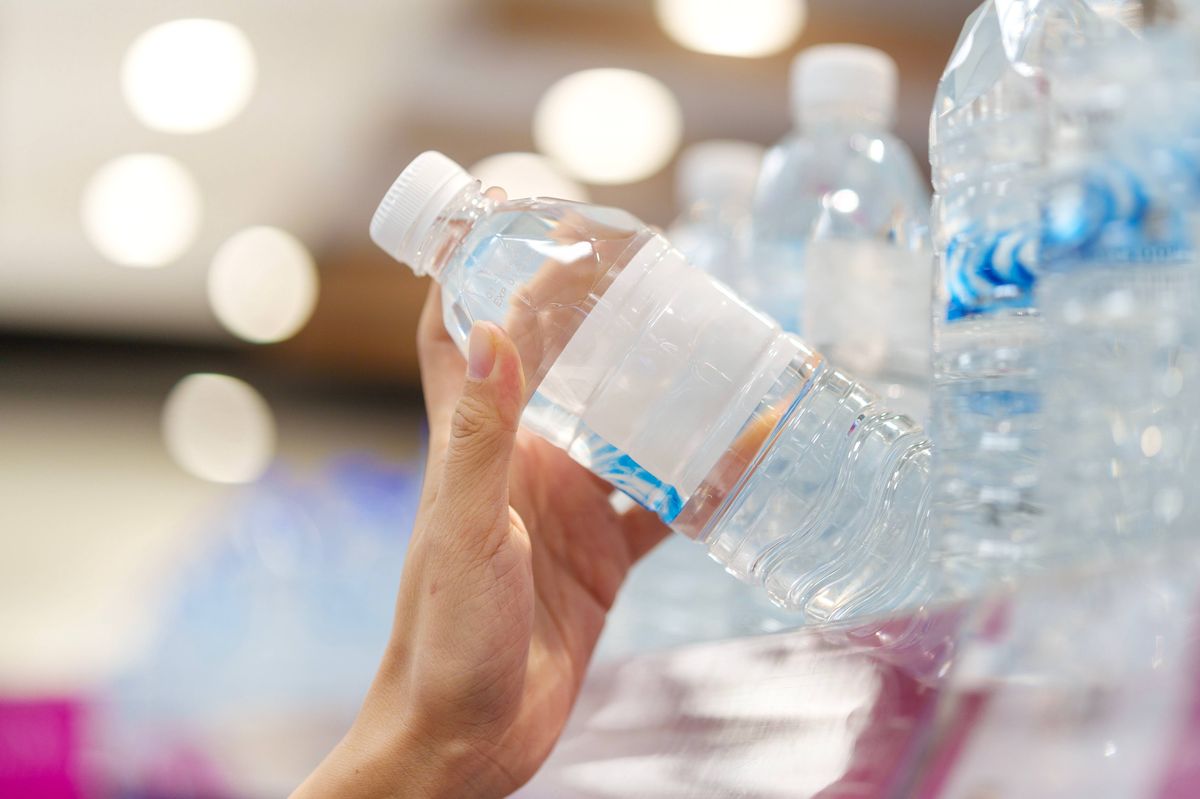 Taking water from supermarket shelf