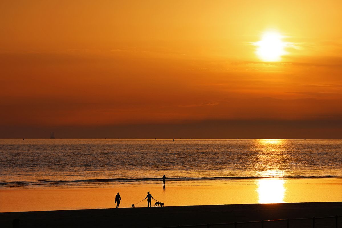 Sun sets on a stunning day at Crosby Beach, Liverpool. Photo by Colin Lane