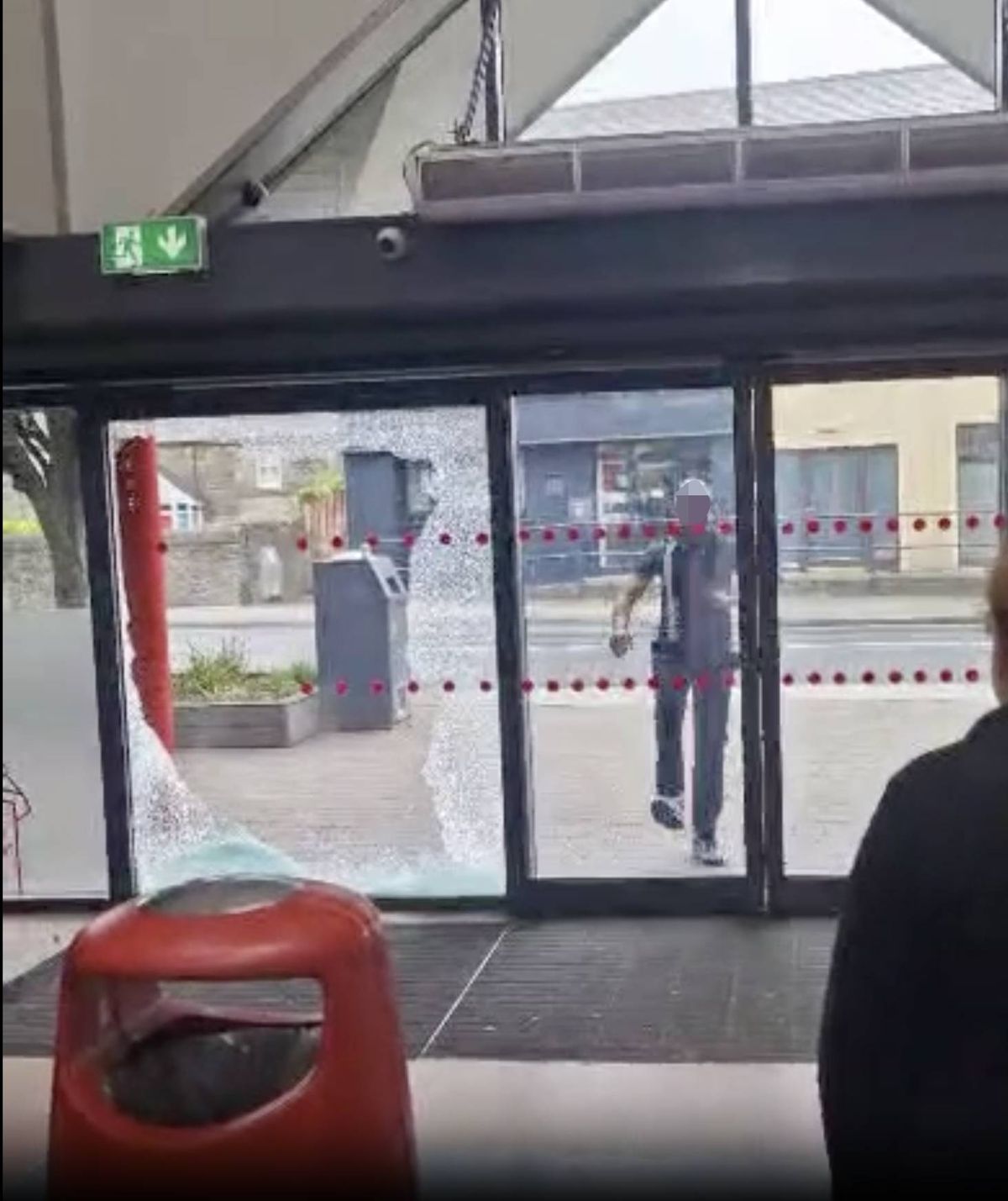 Man kicks through the window of a shop in Donabate, Dublin in a screen grab for a viral video