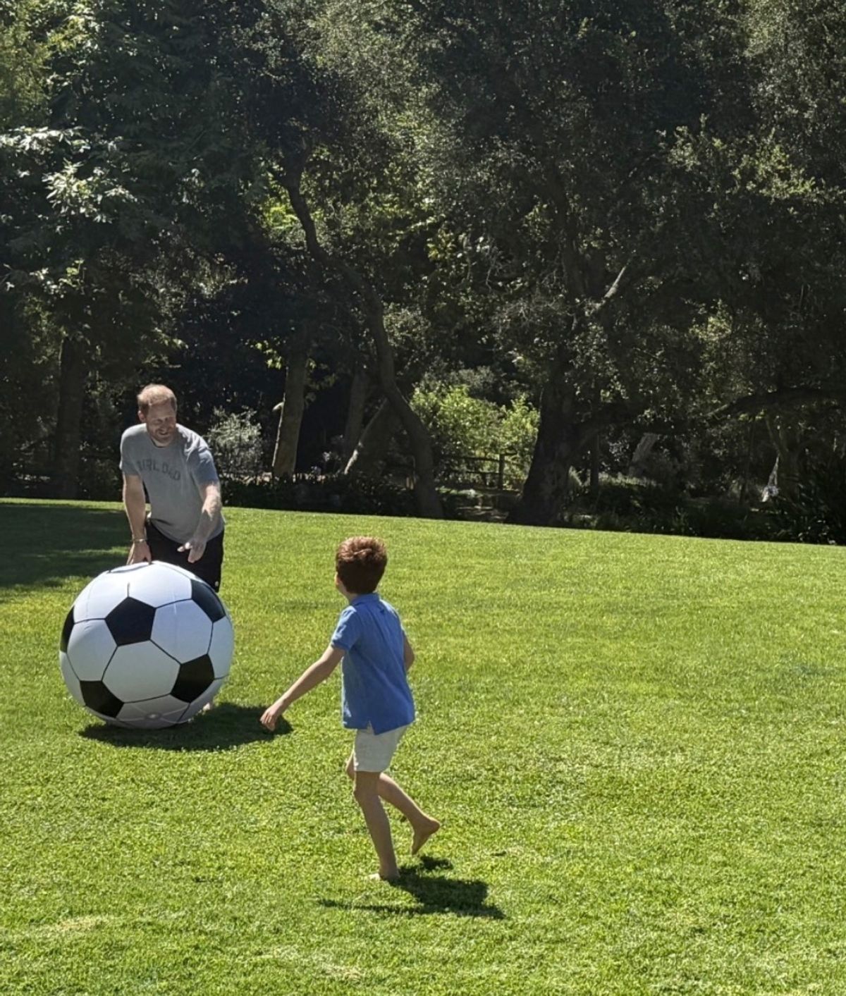 Harry with a giant football playing with Archie