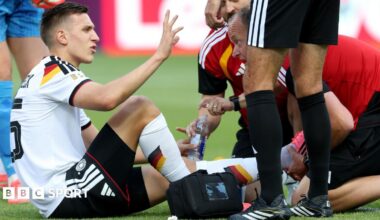 Germany defender Nico Schlotterbeck receives treatment during his side's win against Ivory Coast