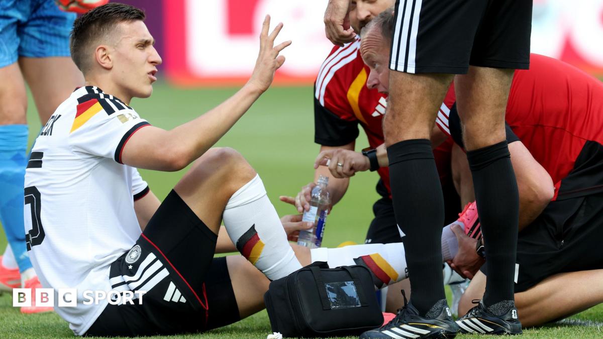 Germany defender Nico Schlotterbeck receives treatment during his side's win against Ivory Coast