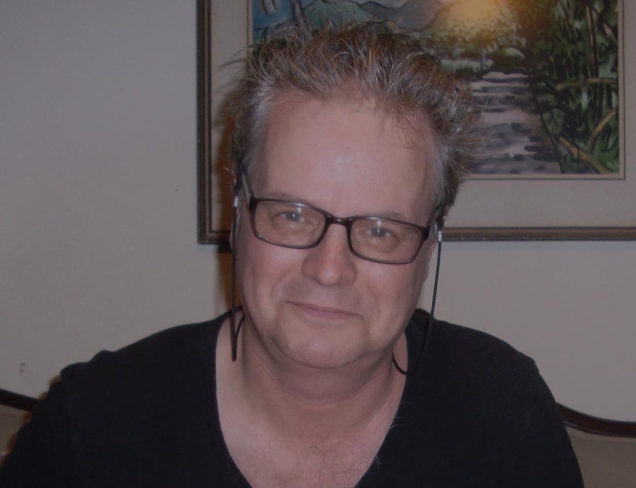 Man with white hair and glasses