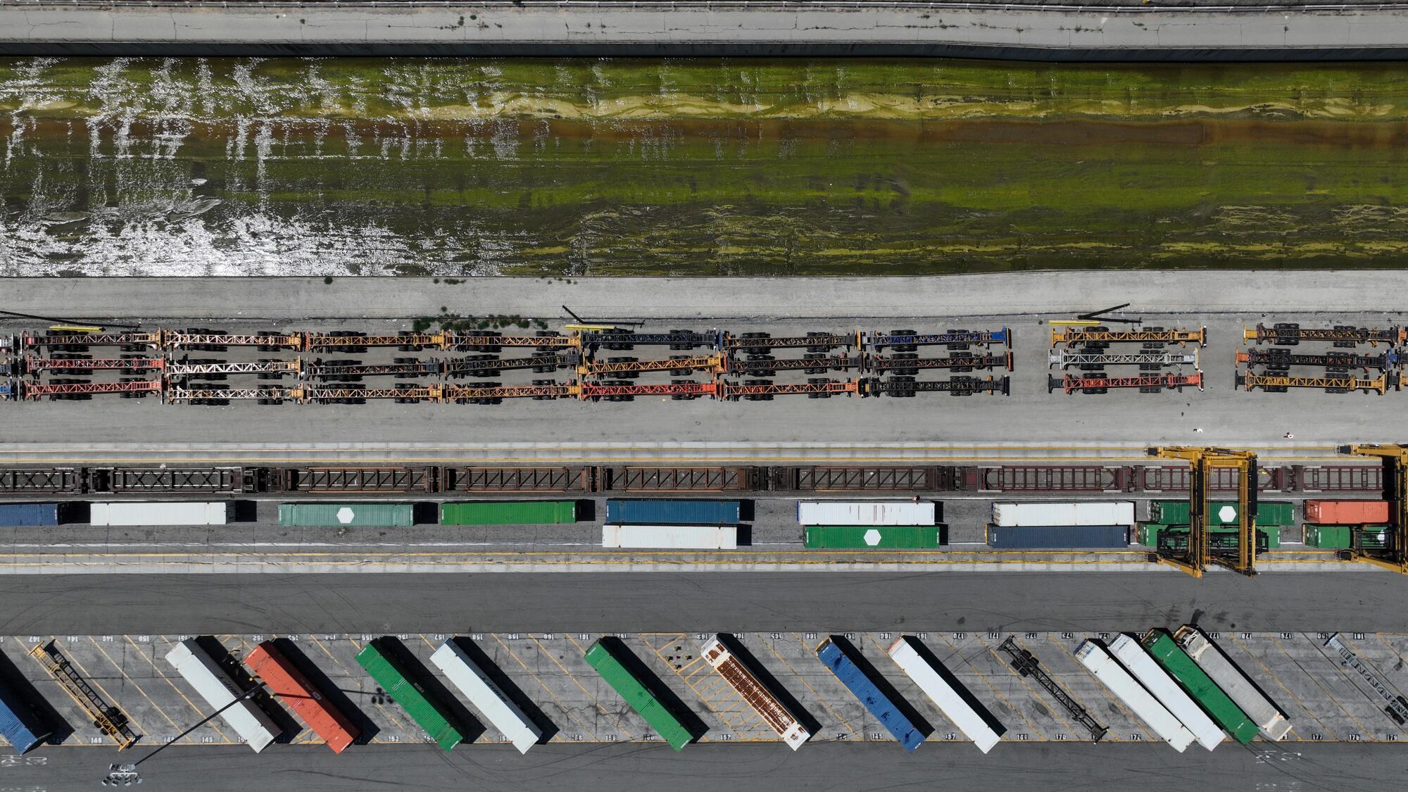 Large parking lots and rail yards along a waterway. 