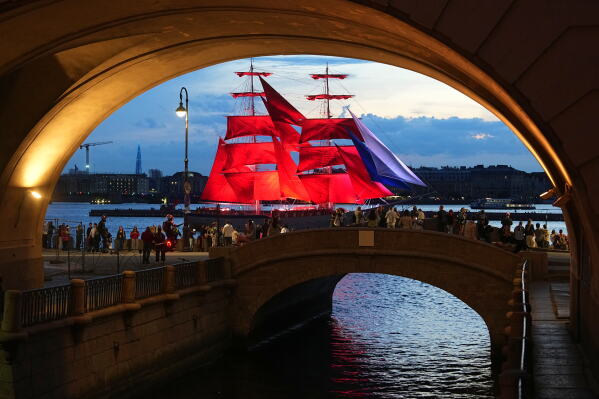 A brig with scarlet sails floats on the Neva River during a rehearsal for the Scarlet Sails festivities marking school graduation in St. Petersburg, Russia, Thursday, June 11, 2026. (AP Photo/Dmitri Lovetsky)
