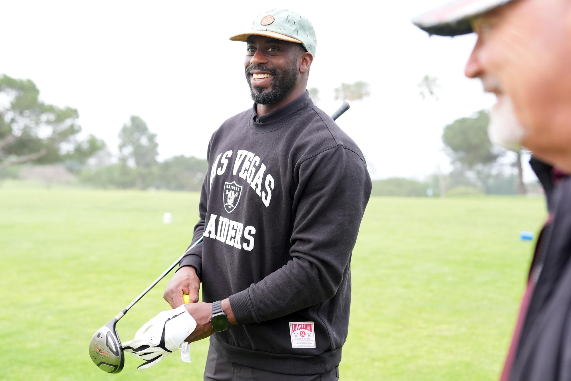 Ose Akhile smiles before teeing off