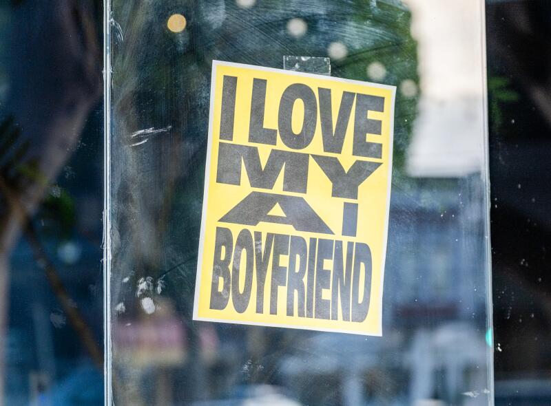 A sign that reads, "I love my AI boyfriend" hangs in a San Francisco window.