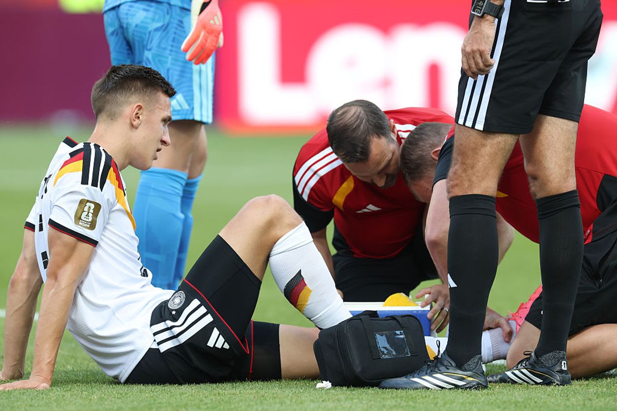 TORONTO, ONTARIO - JUNE 20: Nico Schlotterbeck #15 of Germany receives medical attention during the FIFA World Cup 2026 Group E match between Germany and Cote D'Ivoire at Toronto Stadium on June 20, 2026 in Toronto, Ontario. (Photo by Alexander Hassenstein/Getty Images)