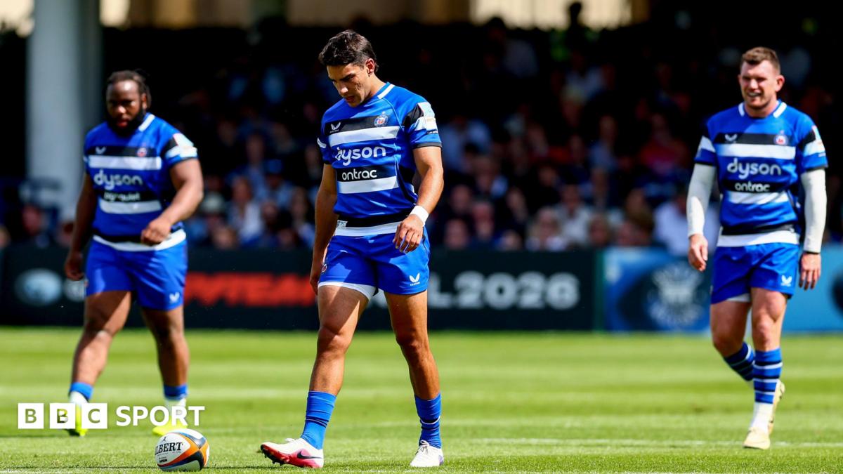 Beno Obano (left), Santiago Carreras (centre) and Ben Spencer (right) walk on the pitch looking dejected after the full-time whistle against Exeter