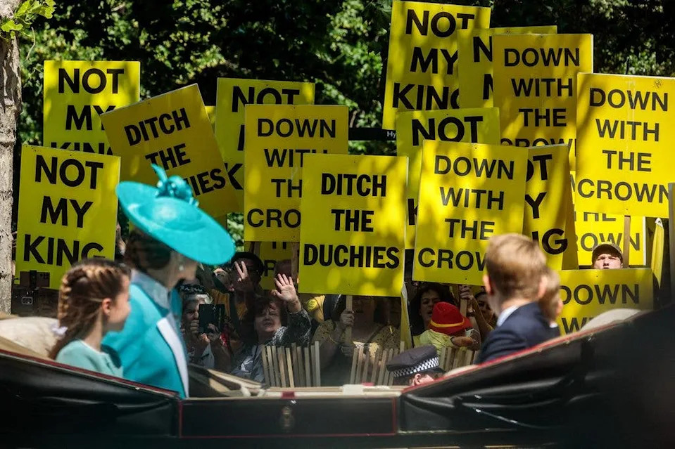 Kate and her children passing the protestors in 2025