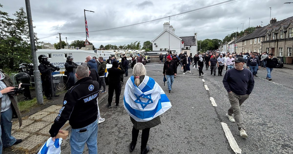 DUP MP defends photo of herself with masked men at protest against Palestine rally – The Irish Times