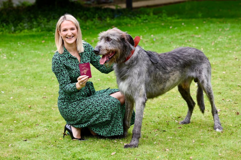 Department of Foreign Affairs Minister Helen McEntee with a mock-up passport and an Irish wolfhound. Photograph: Department of Foreign Affairs/PA Wire