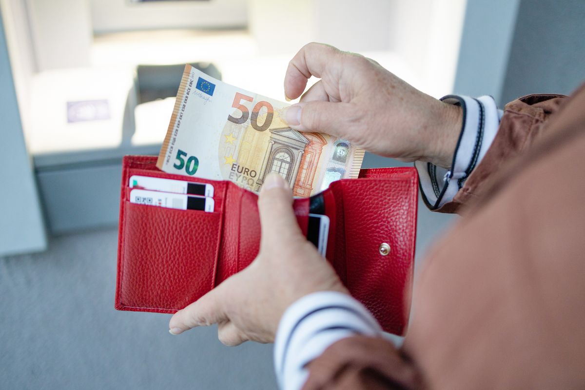 Closeup of woman's hand holding euro banknotes (stock image)
