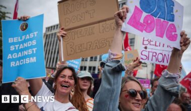 Thousands gather for anti-racism rally in Belfast after disorder - BBC
