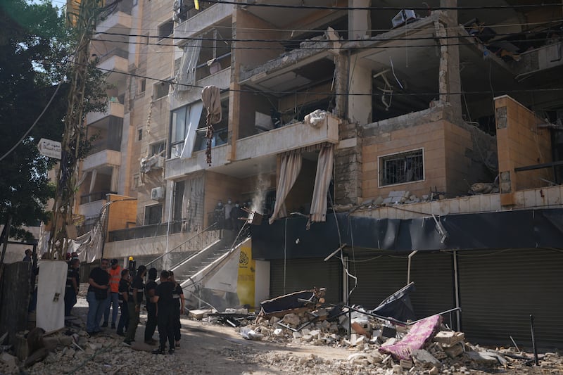 Lebanese security officers gather at the site where an Israeli airstrike hit a building in Dahiyeh in Beirut’s southern suburbs on Sunday. Photograph: Hassan Ammar/AP