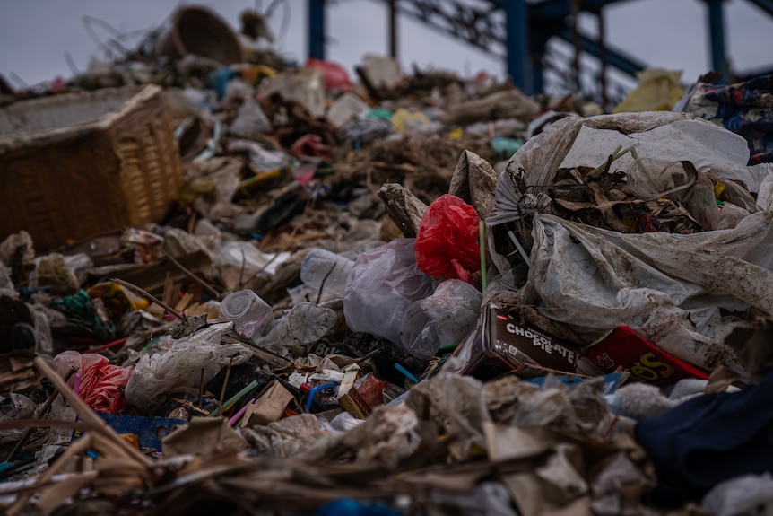 A close up of a pile of rubbish, littered with debris.