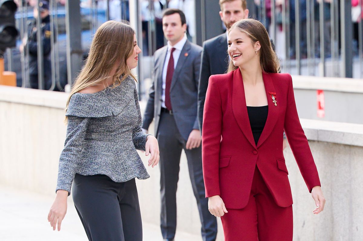 Princess Leonor and Infanta Sofía walking closely together, reflecting their strong sisterly bond.