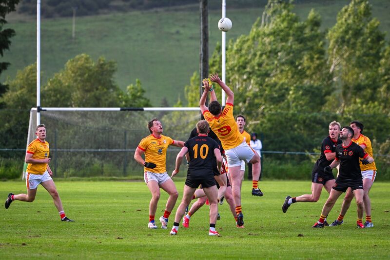 Éire Óg’s Mark Kelleher rises high to claim possession against Newcestown. Picture: Chani Anderson