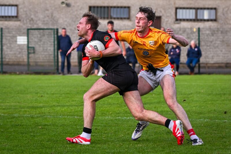 Éire Óg’s Oisín O’Shea tackles Newcestown’s Luke Meade. Picture: Chani Anderson