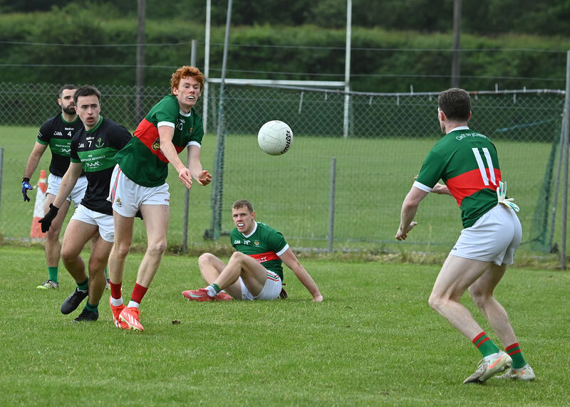 Clonakilty's Des Kenneally passes to Dara Ó Sé and away from Nemo Rangers' Conor Moore and Eoin Nation in the McCarthy Insurance Group Division 1 Football League game in Ahamilla. Picture: Martin Walsh.