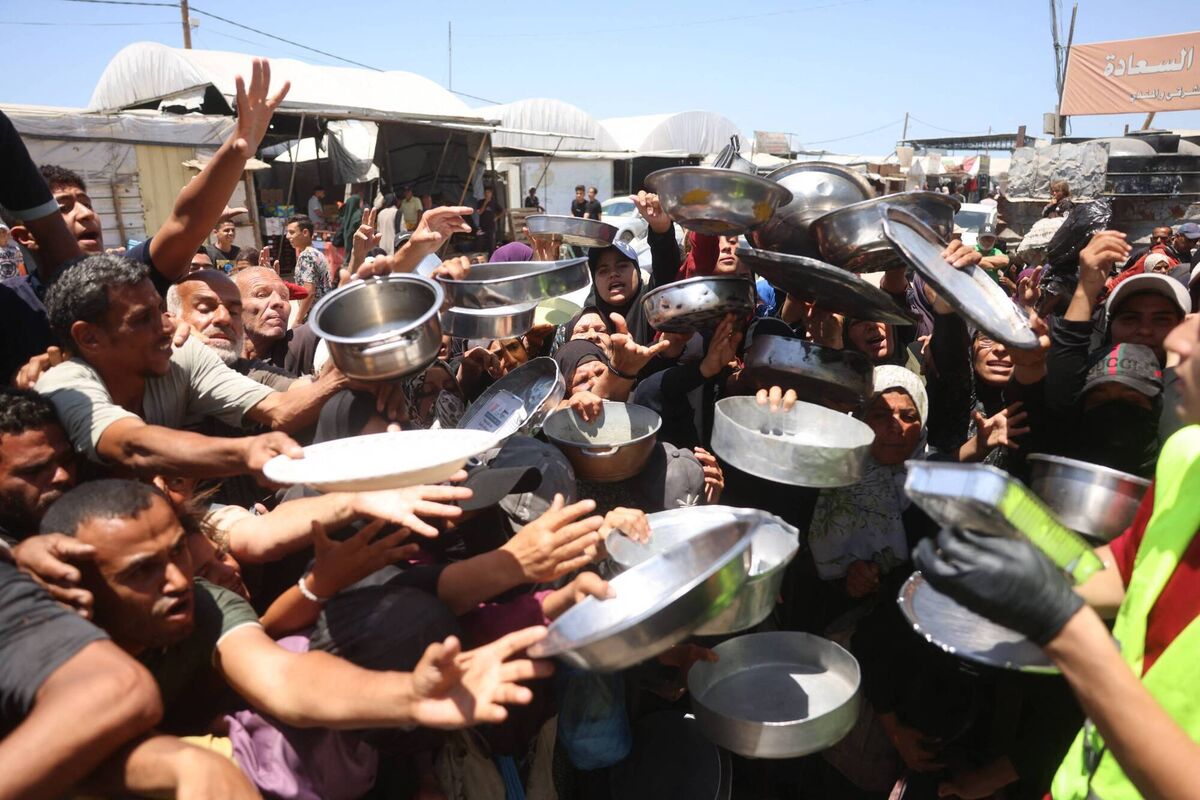 Displaced Palestinians gather to receive food distributed by a charity kitchen in Khan Yunis refugee camp in Gaza  on June 4 amid ongoing shortages of food caused by Israeli attacks and restrictions on aid entering Gaza. Picture: Bashar Taleb/AFP/Getty