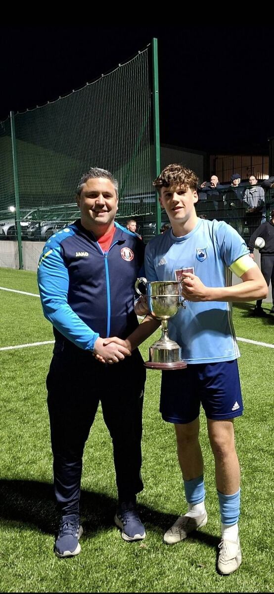 James Fogarty of the Cork Youth League presenting the Daly Industrial Supplies U17 League 1 Cup to Avondale United captain Harry Spratt after their playoff game against Fermoy at Carrig Park recently. KD 