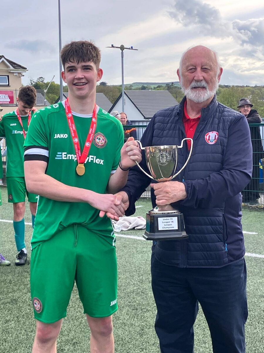 Clonakilty captain Tim Bailey receiving the Daly Industrial Supplies U19 League 1A Cup from Mr Sean O’Sullivan chairman of the Cork Youth League after their game against Carrigaline United at Ballea Park recently. KD 