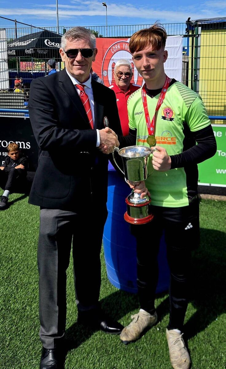 Eddie McEvoy from the Cork Youth League presenting the Daly Industrial Supplies U17 Premier League Cup to Midleton captain Jack Mills after his side best Douglas Hall at Moneygourney recently. KD 