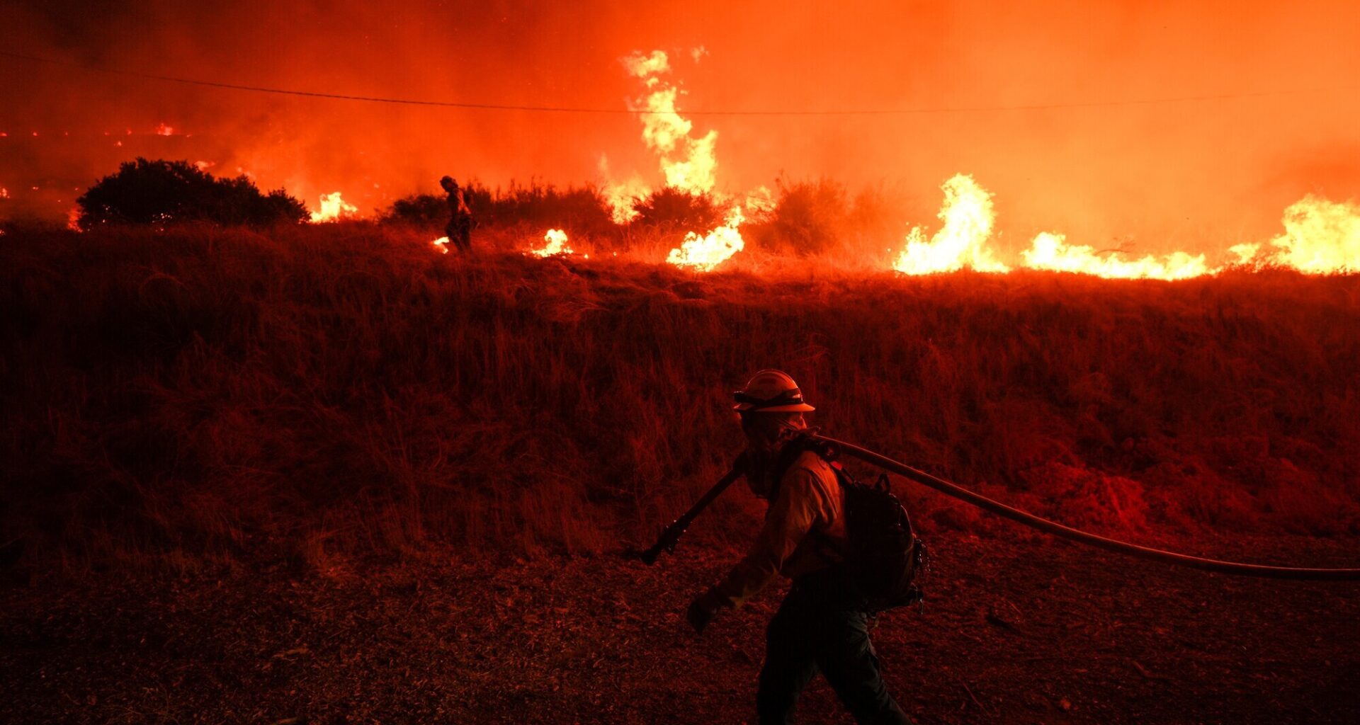 A firefighter monitors a wildfire in California (Jae C. Hong/AP)