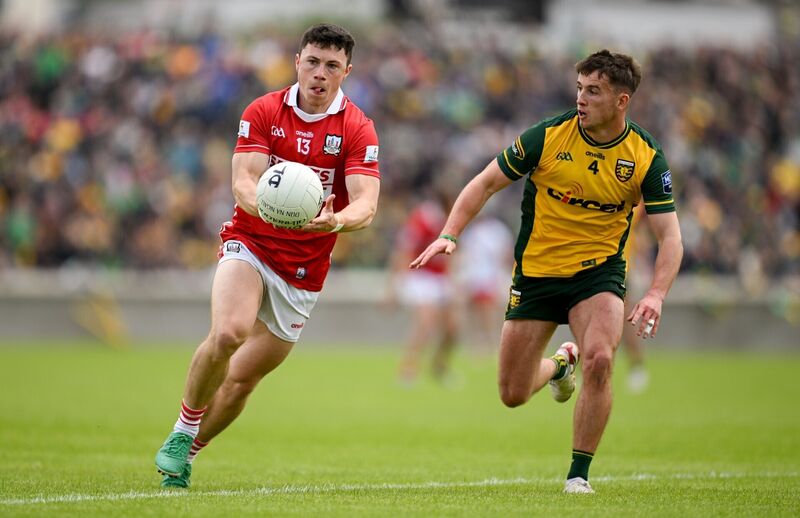 Mark Cronin of Cork in action against Peadar Mogan of Donegal. Picture: Ramsey Cardy/Sportsfile
