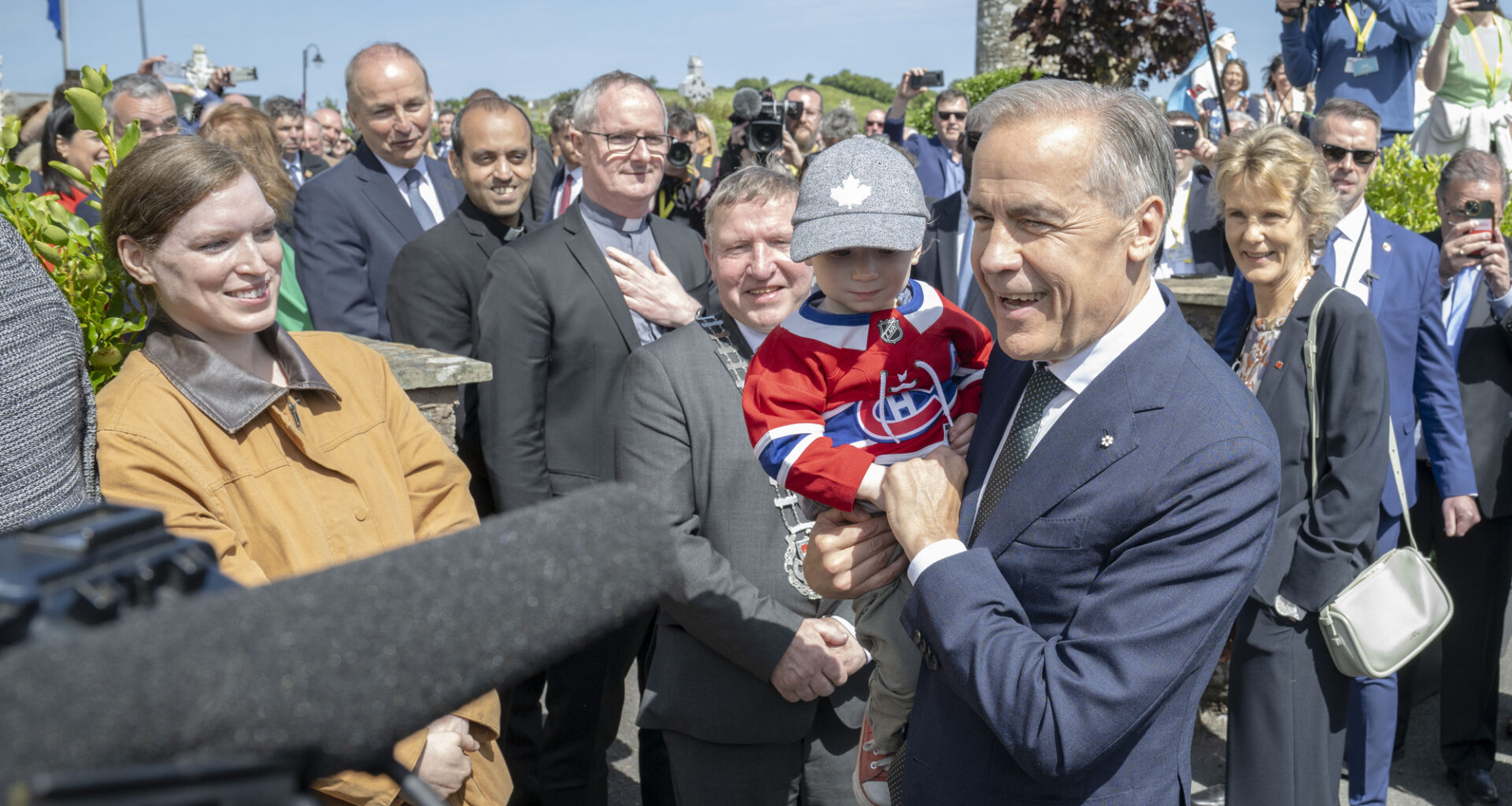Canadian Prime Minister Mark Carney holds toddler Malacy Morgan, during a visit to Aughagower, in Co Mayo, as part of his visit to Ireland. Picture date: Sunday June 14, 2026.