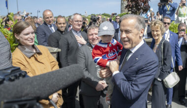Canadian Prime Minister Mark Carney holds toddler Malacy Morgan, during a visit to Aughagower, in Co Mayo, as part of his visit to Ireland. Picture date: Sunday June 14, 2026.