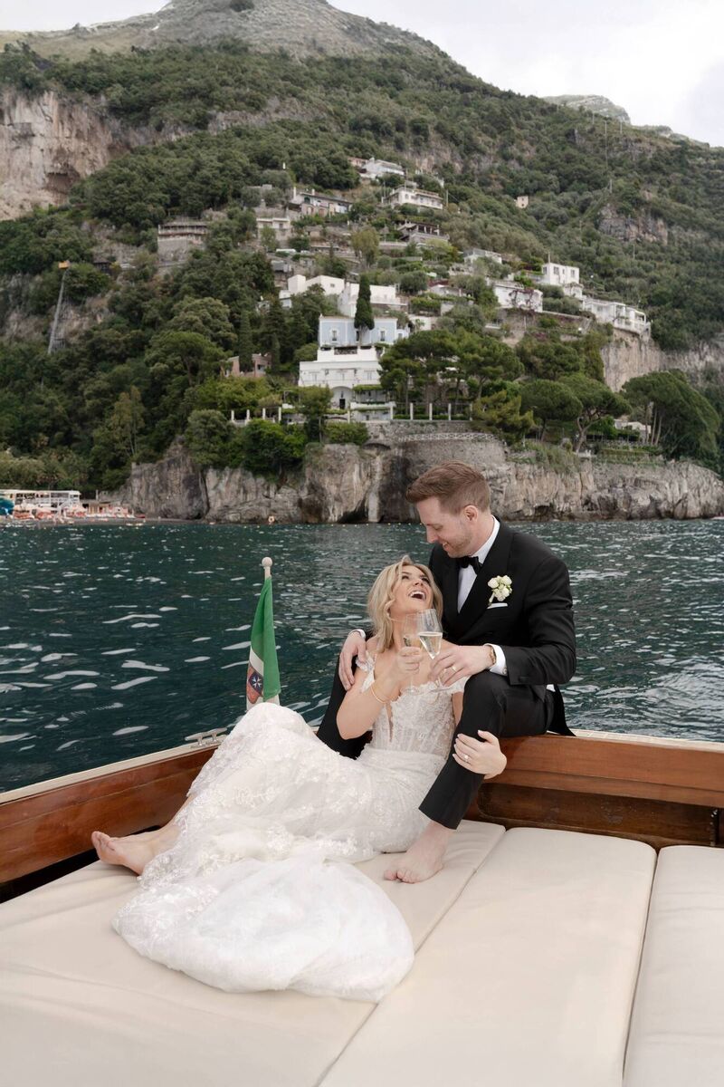 Aisling and Byron on a boat with Positano in the background.