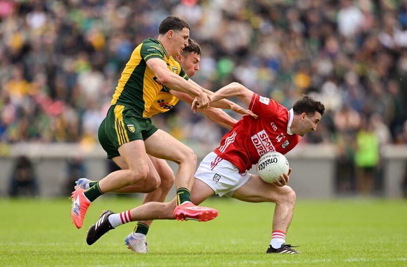 Chris Óg Jones of Cork in action against Finnbarr Roarty and Conor O'Donnell of Donegal. Picture: Ramsey Cardy/Sportsfile
