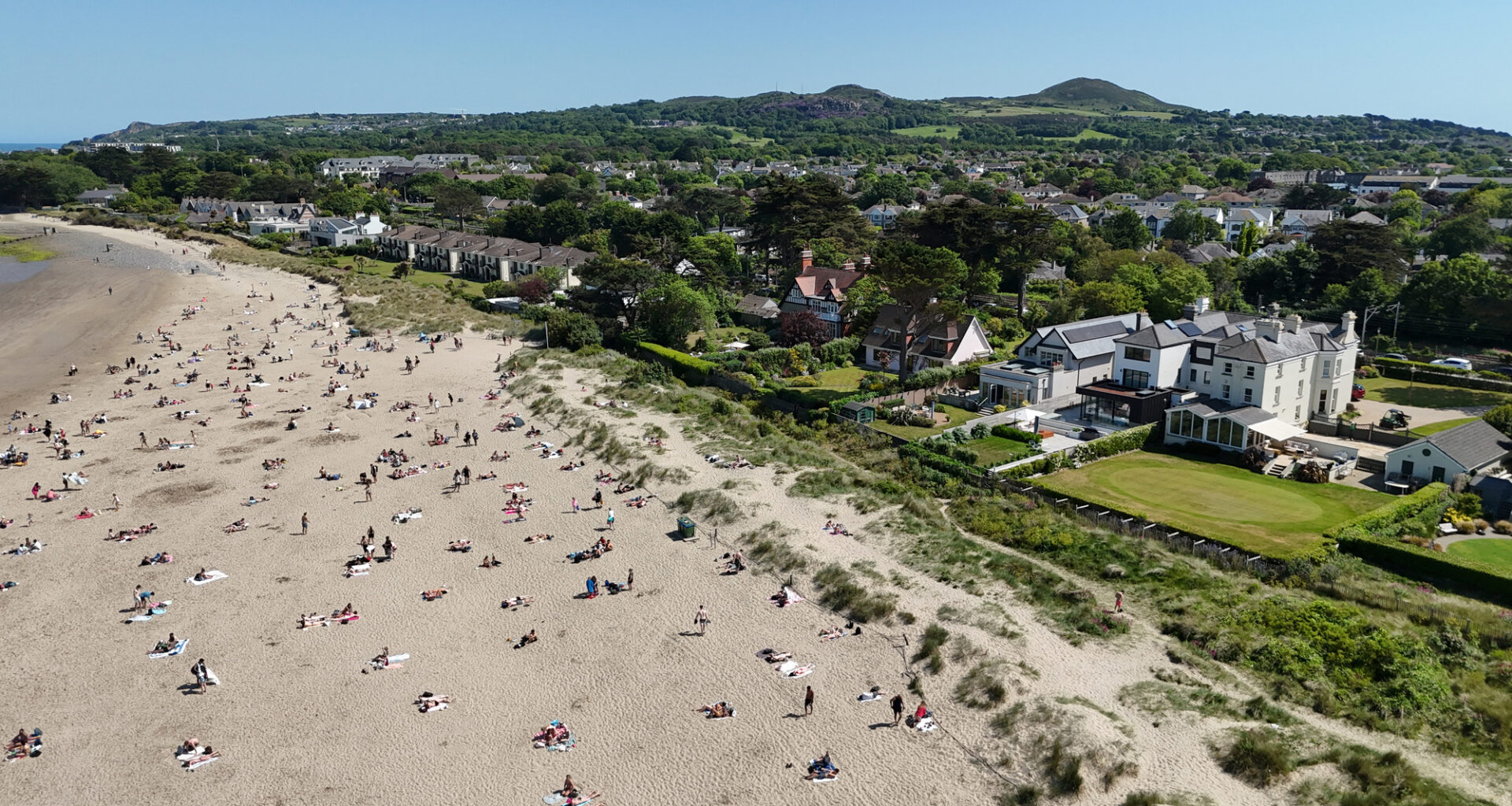 Sunbathers soaked up the sunshine at Burrow Beach in Dublin in May, which saw record-breaking temperatures (PA)