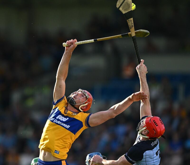 Peter Duggan and Paddy Smyth reach for the sliotar. Picture: David Fitzgerald/Sportsfile