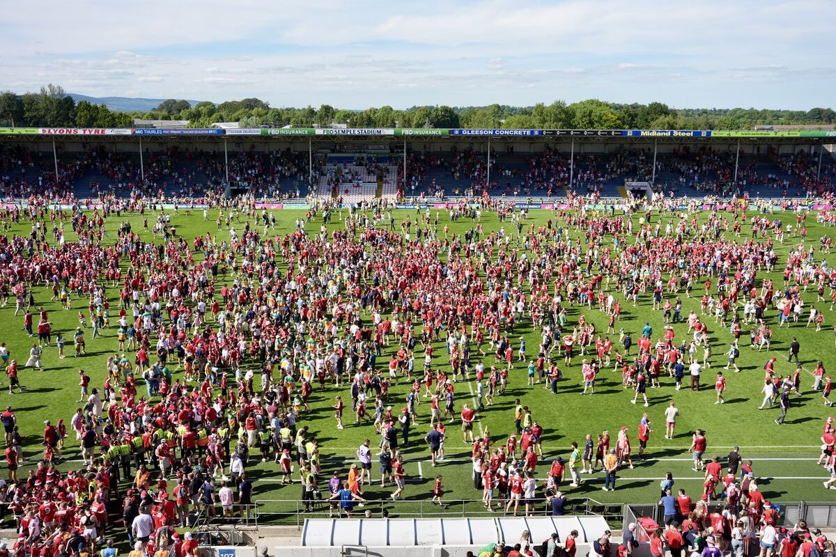 A sea of red descends on to the pitch after the game. Picture :Noel Sweeney