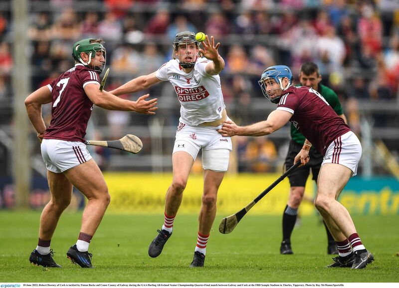 Robert Downey of Cork, in white, is tackled by Fintan Burke and Conor Cooney of Galway during the 2022 All-Ireland SHC quarter-final at FBD Semple Stadium in Thurles. Picture: Ray McManus/Sportsfile