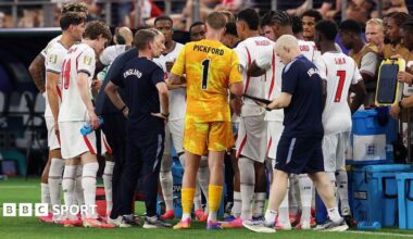 England players gather on the touchline for a hydration break during the 4-2 victory over Croatia at the 2026 FIFA World Cup in  Dallas, Texas