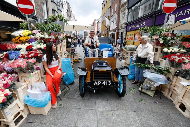 Jim Kiernan in his 122 year old motor with Flower Trader Olivia Cleary. Photograph: Nick Bradshaw/The Irish Times