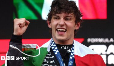 Kimi Antonelli with the Italian flag draped around his shoulders after winning the Monaco Grand Prix