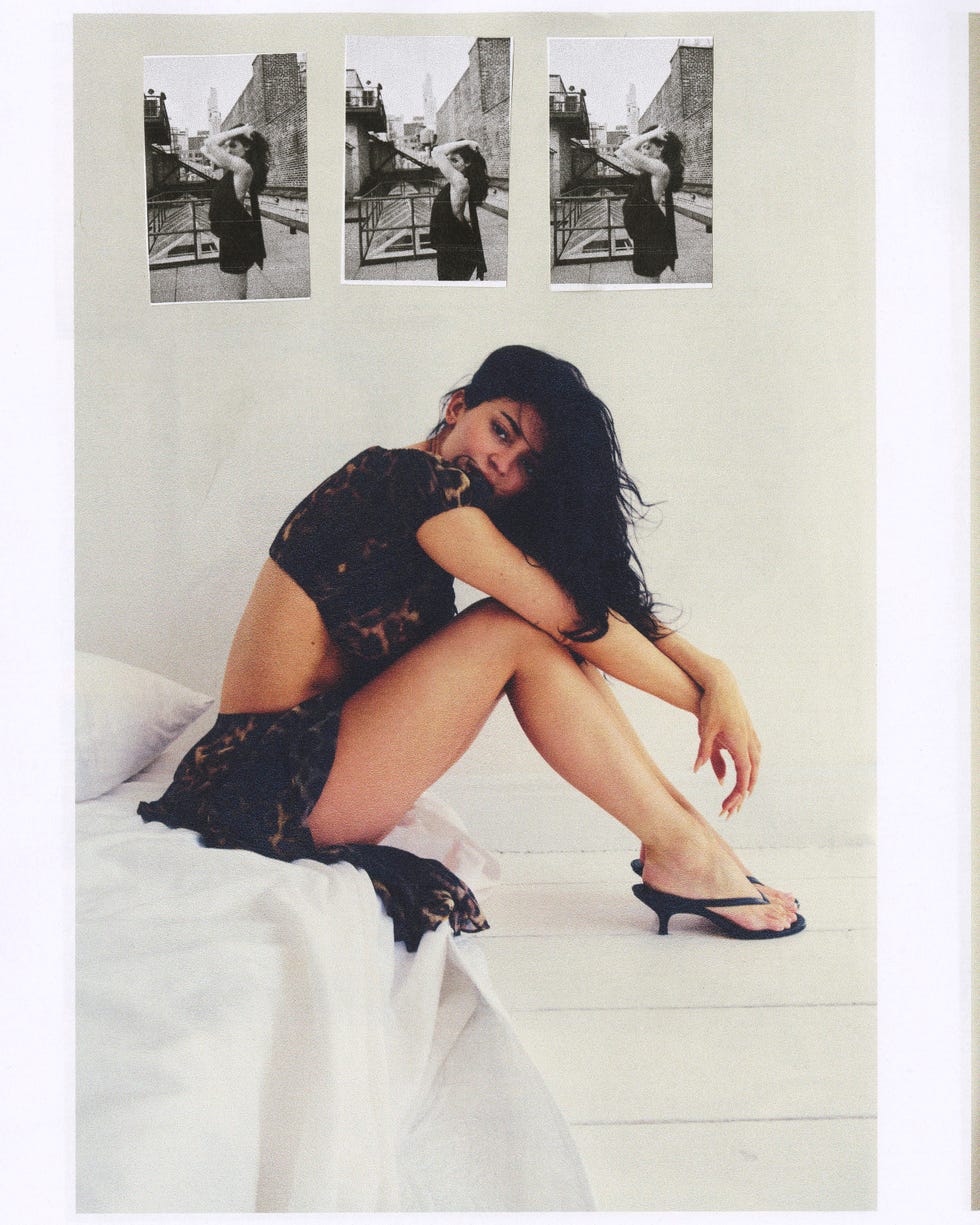 Person sitting on a bed with three black-and-white photos on the wall behind. Person sitting on a bed with three black-and-white photos on the wall behind.